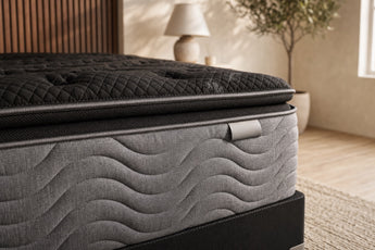 Jamison Clarion Ultra Plush Pillowtop mattress in a styled bedroom, close-up of the pillow-top edge and quilted side