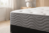Jamison Easton Firm mattress in a styled bedroom, close-up of the pillow-top edge and quilted side