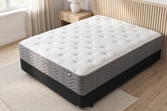 Jamison Easton Firm mattress in a styled bedroom, top view of the quilted sleep surface