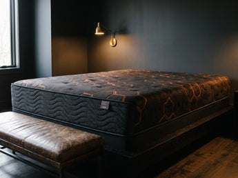 Jamison Sleep Response Apex Pro Cushion Firm mattress, foot-of-bed view in a styled bedroom
