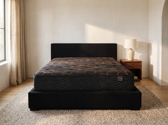 Jamison Sleep Response Elevate Plush mattress, foot-of-bed view in a styled bedroom