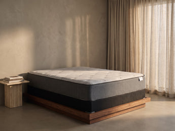 Jamison Sleep Response Ion Plush mattress, three-quarter view in a styled bedroom
