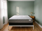 Jamison Sleep Response React Cushion Firm mattress, foot-of-bed view in a styled bedroom