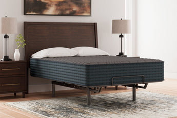 Sierra Sleep Gray 1200 Hybrid Mattress dressed with pillows on a bed frame, bedroom lifestyle view