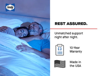 Sealy advertising image featuring a couple peacefully sleeping in bed with soft blue lighting. The right side displays "REST ASSURED." as the headline, followed by "Unmatched support night after night." Below are two icons: a document with "10-Year Warranty" and an American flag with "Made in the USA." The Sealy logo appears in the top left corner. The serene image emphasizes quality sleep and mattress durability benefits.
