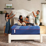 Family lifestyle scene featuring the Sealy Posturepedic Elite Brenham II Hybrid Soft Queen mattress in a primary bedroom