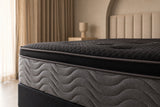 Jamison Clarion Eurotop mattress in a styled bedroom, close-up of the pillow-top edge and quilted side