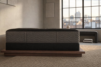 Jamison Clarion Firm mattress in a styled bedroom, side profile showing the mattress height