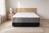 Jamison Easton Firm mattress in a styled bedroom, foot-of-bed view