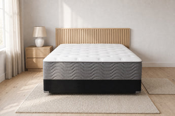 Jamison Easton Firm mattress in a styled bedroom, foot-of-bed view