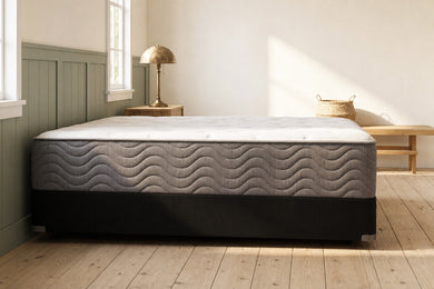 Jamison Easton Plush mattress in a styled bedroom, side profile showing the mattress height