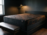 Jamison Sleep Response Apex Pro Cushion Firm mattress, three-quarter view in a styled bedroom