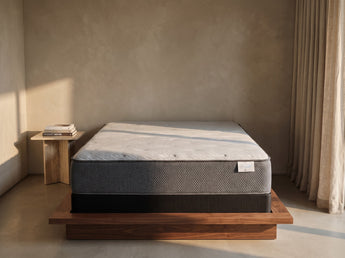 Jamison Sleep Response Ion Plush mattress, foot-of-bed view in a styled bedroom