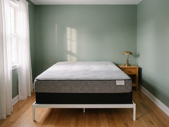 Jamison Sleep Response React Cushion Firm mattress, foot-of-bed view in a styled bedroom